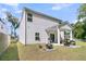 Exterior view of the home showcasing the backyard with patio and fire pit at 707 Jancus St, Charleston, SC 29414