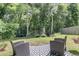 Landscaped backyard featuring a trampoline, playhouse, and outdoor seating area at 707 Jancus St, Charleston, SC 29414