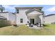 Back exterior view of home with patio, fire pit, and grill with room to entertain at 707 Jancus St, Charleston, SC 29414