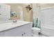 Well-lit bathroom features a shower with curtain, white vanity, and decorative wall art at 707 Jancus St, Charleston, SC 29414