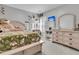 A comfy bedroom with decorative shelves, a large bed, and shuttered windows at 707 Jancus St, Charleston, SC 29414