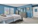 Bright bedroom with blue walls, shuttered windows, and elegant wooden furniture at 707 Jancus St, Charleston, SC 29414