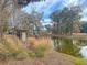 Stone sign marking the community entrance, set amidst a scenic pond and greenery at 707 Jancus St, Charleston, SC 29414