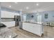 Bright, open kitchen with white cabinets, stainless steel appliances, granite counters, and island with seating at 707 Jancus St, Charleston, SC 29414