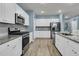 Well-equipped kitchen featuring stainless steel appliances, ample counter space, and modern finishes at 707 Jancus St, Charleston, SC 29414