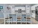 Stylish kitchen featuring a granite countertop island with seating, stainless steel appliances, and white cabinets at 707 Jancus St, Charleston, SC 29414