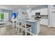 Bright open-concept features counter seating and modern appliances, flowing to living area at 707 Jancus St, Charleston, SC 29414
