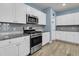 Well-equipped kitchen boasting stainless steel appliances, granite countertops, and ample white cabinetry at 707 Jancus St, Charleston, SC 29414
