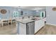Open-concept kitchen showcasing a granite island with a sink, stainless steel dishwasher, and dining area nearby at 707 Jancus St, Charleston, SC 29414