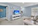 Comfortable blue living room with a modern TV, a white console, and tan sofa at 707 Jancus St, Charleston, SC 29414