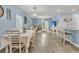 Open-concept living and dining area with modern flooring, a dining table, and a comfortable seating area at 707 Jancus St, Charleston, SC 29414