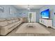 Comfortable living room with a plush sectional sofa, decorative rug, and entertainment center with a large TV at 707 Jancus St, Charleston, SC 29414
