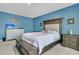 Comfortable main bedroom features a large bed, handsome furnishings, and bright blue walls at 707 Jancus St, Charleston, SC 29414