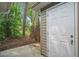 Backyard exterior with a partial view of a door and the wooded backyard at 7999 Vermont Rd, North Charleston, SC 29418