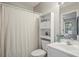 Bathroom featuring white cabinets and shelving, a toilet, and a neutral-colored shower curtain at 7999 Vermont Rd, North Charleston, SC 29418