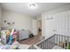 Bedroom with a crib, wood-look floors, and a view to other rooms at 7999 Vermont Rd, North Charleston, SC 29418