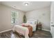 Bedroom featuring wood-look flooring, neutral walls, and a bright window at 7999 Vermont Rd, North Charleston, SC 29418