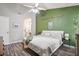 Bedroom featuring a green accent wall, ceiling fan, and wood-look floors at 7999 Vermont Rd, North Charleston, SC 29418