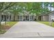 Charming single-story home with a spacious driveway and lush landscaping at 7999 Vermont Rd, North Charleston, SC 29418