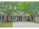 Charming home featuring a well-maintained lawn, mature trees, and welcoming curb appeal at 7999 Vermont Rd, North Charleston, SC 29418