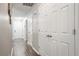 Hallway with faux wood flooring, doors, light gray walls, white ceilings, and access to other rooms at 7999 Vermont Rd, North Charleston, SC 29418