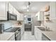 Bright kitchen features white cabinets, stainless steel appliances, and sleek countertops at 7999 Vermont Rd, North Charleston, SC 29418