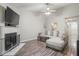 Cozy living room with a fireplace, ceiling fan, and comfortable seating at 7999 Vermont Rd, North Charleston, SC 29418