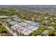 Aerial view of community tennis courts, parking, and lush trees at 9002 Palmetto Dr # 119, Isle of Palms, SC 29451