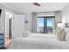 Cozy bedroom with a sliding glass door that opens up to a large ocean view balcony at 9002 Palmetto Dr # 119, Isle of Palms, SC 29451