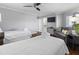 Comfortable bedroom with two beds, ensuite bathroom, television, and natural light at 9002 Palmetto Dr # 119, Isle of Palms, SC 29451
