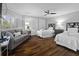 Comfortable bedroom featuring two beds, a sitting area with a sofa, and a large window with natural light at 9002 Palmetto Dr # 119, Isle of Palms, SC 29451