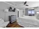 Comfortable bedroom with a large bed, wood floors, a ceiling fan, and great natural light at 9002 Palmetto Dr # 119, Isle of Palms, SC 29451
