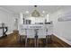 Beautiful dining room with modern light fixture, seating for six, and seamless transition to the kitchen at 9002 Palmetto Dr # 119, Isle of Palms, SC 29451