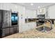 Bright kitchen features stainless steel appliances, granite countertops, and white cabinets at 9002 Palmetto Dr # 119, Isle of Palms, SC 29451