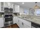 Modern kitchen featuring stainless steel appliances and granite countertops with bar seating at 9002 Palmetto Dr # 119, Isle of Palms, SC 29451
