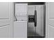 Convenient laundry area with stackable washer and dryer and a full-sized refrigerator at 9002 Palmetto Dr # 119, Isle of Palms, SC 29451