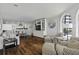 Open-concept living room featuring hardwood floors, built-in shelving and large arched window with ocean views at 9002 Palmetto Dr # 119, Isle of Palms, SC 29451