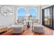 Cozy sitting area with stylish chairs and a tranquil ocean view through arched windows at 9002 Palmetto Dr # 119, Isle of Palms, SC 29451