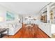 Open living space with hardwood floors, a sofa, built-in shelving, and connecting dining area at 9002 Palmetto Dr # 119, Isle of Palms, SC 29451