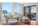 Bright sitting area featuring stylish chairs, ocean views, and access to a private balcony at 9002 Palmetto Dr # 119, Isle of Palms, SC 29451