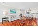 Inviting living room with hardwood floors, stylish sofa, and a view of the adjacent dining area at 9002 Palmetto Dr # 119, Isle of Palms, SC 29451