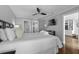 Bright main bedroom with a ceiling fan, walk-in closet, television, and ensuite bathroom at 9002 Palmetto Dr # 119, Isle of Palms, SC 29451