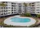 Community pool with lush landscaping and nearby covered parking at 9002 Palmetto Dr # 119, Isle of Palms, SC 29451