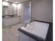 Relaxing bathroom featuring a soaking tub, double vanities, and modern finishes at 945 Tiger Loop, Saint Stephen, SC 29479