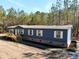 Charming single-story home featuring blue siding, white trim, and a lovely wooden deck entrance at 945 Tiger Loop, Saint Stephen, SC 29479