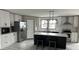 Modern kitchen with white cabinets, stainless steel appliances, and a kitchen island at 945 Tiger Loop, Saint Stephen, SC 29479