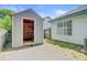 View of backyard shed and partial view of home with ample room and gravel driveway at 9630 Crosscut Dr, Ladson, SC 29456