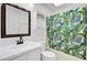 Bathroom featuring a white vanity, toilet, and tiled shower with leaf patterned curtain at 9630 Crosscut Dr, Ladson, SC 29456