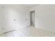 A bedroom with neutral tiled floors and a closet with an open door at 9630 Crosscut Dr, Ladson, SC 29456