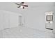 Spacious bedroom with vaulted ceilings, white walls and tile floors, leading to bathroom at 9630 Crosscut Dr, Ladson, SC 29456